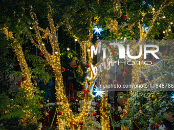 Visitors look at a Christmas tree installation at the Halo Shopping Park in Chongqing, China, on December 8, 2024. (