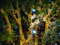 Visitors look at a Christmas tree installation at the Halo Shopping Park in Chongqing, China, on December 8, 2024. (