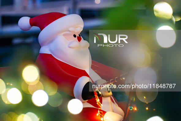 Visitors look at a Santa Claus installation at the Halo Shopping Park in Chongqing, China, on December 8, 2024. 