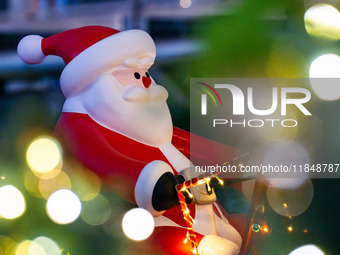 Visitors look at a Santa Claus installation at the Halo Shopping Park in Chongqing, China, on December 8, 2024. (