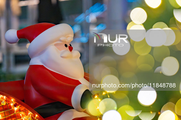 Visitors look at a Santa Claus installation at the Halo Shopping Park in Chongqing, China, on December 8, 2024. 