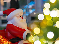 Visitors look at a Santa Claus installation at the Halo Shopping Park in Chongqing, China, on December 8, 2024. (