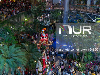 Visitors look at a Santa Claus installation at the Halo Shopping Park in Chongqing, China, on December 8, 2024. (