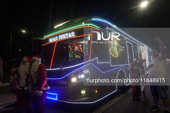 People admire the Ibirapuera Christmas tree in Sao Paulo, Brazil, on December 8, 2024. The tree's steel structure measures 18.5 meters in di...