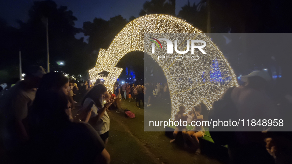 People admire the Ibirapuera Christmas tree in Sao Paulo, Brazil, on December 8, 2024. The tree's steel structure measures 18.5 meters in di...