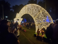 People admire the Ibirapuera Christmas tree in Sao Paulo, Brazil, on December 8, 2024. The tree's steel structure measures 18.5 meters in di...