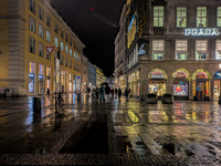 On a rainy evening in Munich, Bavaria, Germany, on December 8, 2024, during the Christmas season, the streets come alive with the glow of fe...