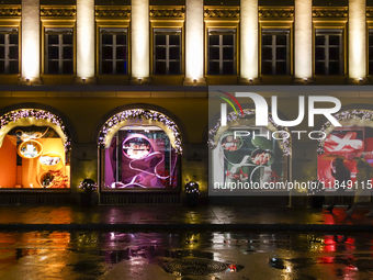 On a rainy evening in Munich, Bavaria, Germany, on December 8, 2024, during the Christmas season, the streets come alive with the glow of fe...