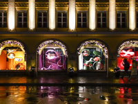 On a rainy evening in Munich, Bavaria, Germany, on December 8, 2024, during the Christmas season, the streets come alive with the glow of fe...