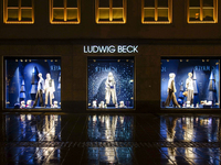 On a rainy evening in Munich, Bavaria, Germany, on December 8, 2024, during the Christmas season, the streets come alive with the glow of fe...