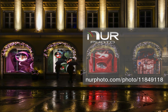 On a rainy evening in Munich, Bavaria, Germany, on December 8, 2024, during the Christmas season, the streets come alive with the glow of fe...