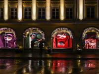 On a rainy evening in Munich, Bavaria, Germany, on December 8, 2024, during the Christmas season, the streets come alive with the glow of fe...