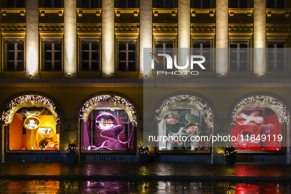 On a rainy evening in Munich, Bavaria, Germany, on December 8, 2024, during the Christmas season, the streets come alive with the glow of fe...