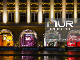 On a rainy evening in Munich, Bavaria, Germany, on December 8, 2024, during the Christmas season, the streets come alive with the glow of fe...