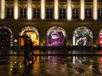 On a rainy evening in Munich, Bavaria, Germany, on December 8, 2024, during the Christmas season, the streets come alive with the glow of fe...