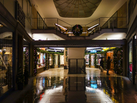 On a rainy evening in Munich, Bavaria, Germany, on December 8, 2024, during the Christmas season, the streets come alive with the glow of fe...