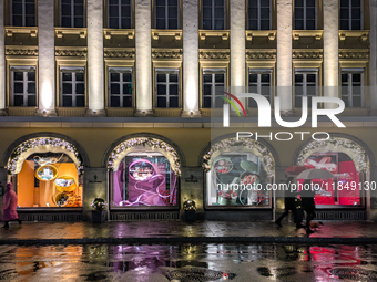 On a rainy evening in Munich, Bavaria, Germany, on December 8, 2024, during the Christmas season, the streets come alive with the glow of fe...