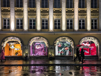 On a rainy evening in Munich, Bavaria, Germany, on December 8, 2024, during the Christmas season, the streets come alive with the glow of fe...