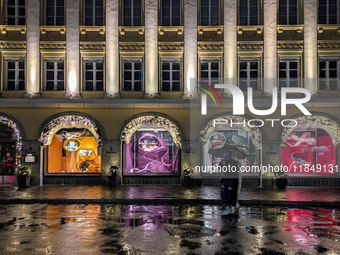 On a rainy evening in Munich, Bavaria, Germany, on December 8, 2024, during the Christmas season, the streets come alive with the glow of fe...