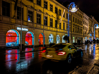 On a rainy evening in Munich, Bavaria, Germany, on December 8, 2024, during the Christmas season, the streets come alive with the glow of fe...