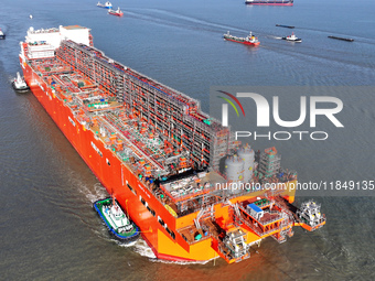 The NGUYA FLNG ship, China's first large floating natural gas liquefaction plant, sails on the Taicang section of the Yangtze River in Suzho...