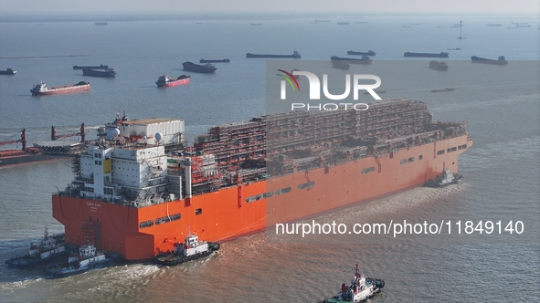 The NGUYA FLNG ship, China's first large floating natural gas liquefaction plant, sails on the Taicang section of the Yangtze River in Suzho...