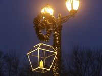 A lamppost decorated with a garland and a lantern is in the street during the Christmas season in Kharkiv, Ukraine, on December 7, 2024. (