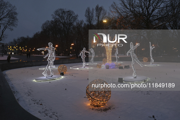 An installation featuring figures of ice skaters decorates the street during the Christmas season in Kharkiv, Ukraine, on December 7, 2024....