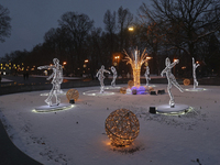 An installation featuring figures of ice skaters decorates the street during the Christmas season in Kharkiv, Ukraine, on December 7, 2024....