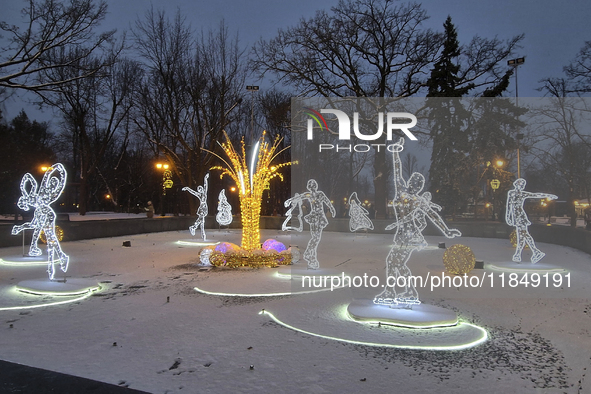 An installation featuring figures of ice skaters decorates the street during the Christmas season in Kharkiv, Ukraine, on December 7, 2024....