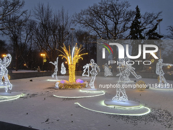 An installation featuring figures of ice skaters decorates the street during the Christmas season in Kharkiv, Ukraine, on December 7, 2024....