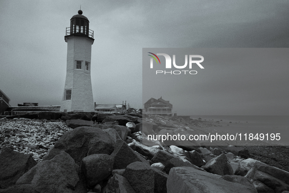 The Bates Lighthouse in Scituate greets a new day with the first snowfall of the year. 