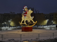 An installation featuring a large Santa Claus on a rocking horse decorates the street during the Christmas season in Kharkiv, Ukraine, on De...