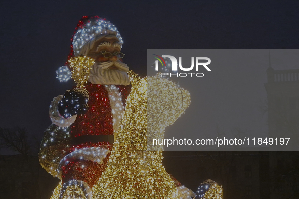 An installation featuring a large Santa Claus on a rocking horse decorates the street during the Christmas season in Kharkiv, Ukraine, on De...