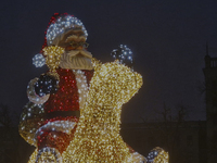 An installation featuring a large Santa Claus on a rocking horse decorates the street during the Christmas season in Kharkiv, Ukraine, on De...