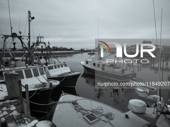 A ''long-liner'' fishing boat that seeks swordfish leaves Scituate Harbor early in the morning after a fresh snow. (