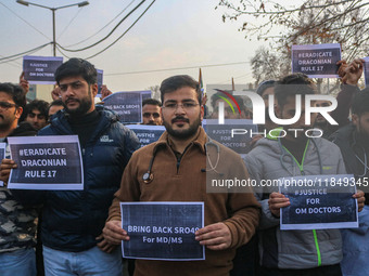 Bachelor of Medicine and Bachelor of Surgery (MBBS) students and doctors hold placards during a protest against excessive reservation in com...