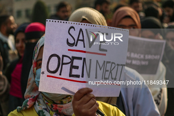 A student of Bachelor of Medicine and Bachelor of Surgery (MBBS) holds a placard during a protest against excessive reservation in competiti...