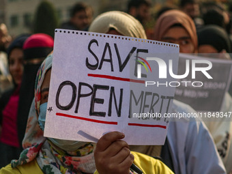 A student of Bachelor of Medicine and Bachelor of Surgery (MBBS) holds a placard during a protest against excessive reservation in competiti...