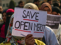 A student of Bachelor of Medicine and Bachelor of Surgery (MBBS) holds a placard during a protest against excessive reservation in competiti...