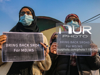 Students of Bachelor of Medicine and Bachelor of Surgery (MBBS) hold placards during a protest against excessive reservation in competitive...