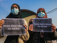 Students of Bachelor of Medicine and Bachelor of Surgery (MBBS) hold placards during a protest against excessive reservation in competitive...