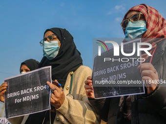 Students of Bachelor of Medicine and Bachelor of Surgery (MBBS) hold placards during a protest against excessive reservation in competitive...