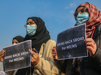 Students of Bachelor of Medicine and Bachelor of Surgery (MBBS) hold placards during a protest against excessive reservation in competitive...