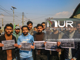 Bachelor of Medicine and Bachelor of Surgery (MBBS) students and doctors hold placards during a protest against excessive reservation in com...