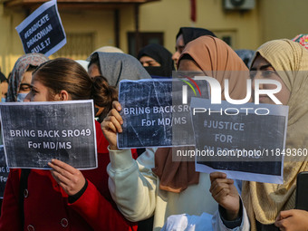 Students of Bachelor of Medicine and Bachelor of Surgery (MBBS) hold placards during a protest against excessive reservation in competitive...