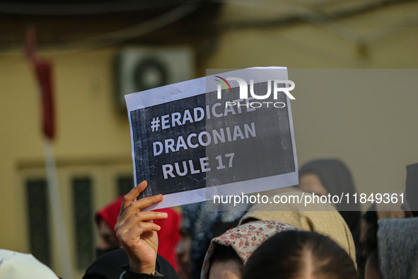 A student of Bachelor of Medicine and Bachelor of Surgery (MBBS) holds a placard during a protest against excessive reservation in competiti...