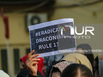 A student of Bachelor of Medicine and Bachelor of Surgery (MBBS) holds a placard during a protest against excessive reservation in competiti...