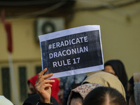 A student of Bachelor of Medicine and Bachelor of Surgery (MBBS) holds a placard during a protest against excessive reservation in competiti...