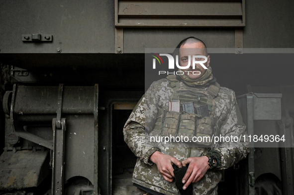 An artilleryman of Ukraine's 118th Separate Mechanized Brigade stands by a self-propelled howitzer while on a mission in the Zaporizhzhia di...